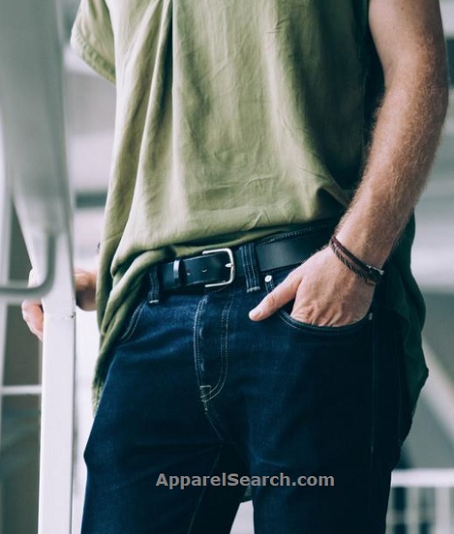 Man wearing an olive t-shirt, dark jeans and a black leather belt, shown from the waist down
