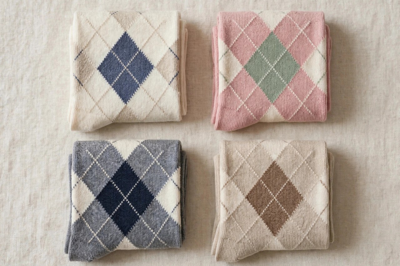Neatly folded women's cotton argyle socks with a classic diamond pattern on a clean background