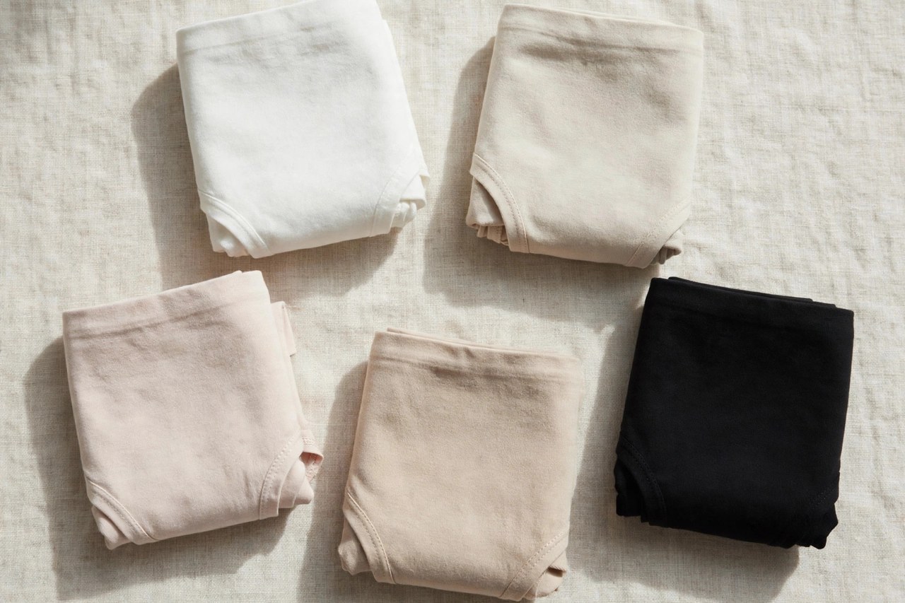 Neatly folded women's cotton boxer shorts in plain woven cotton on a clean neutral background
