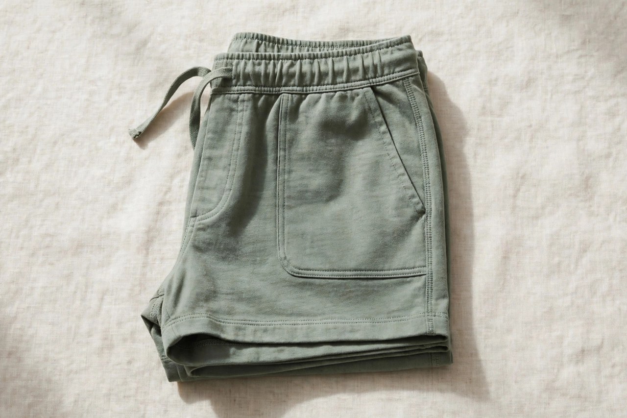 Neatly folded women's cotton gym shorts in classic athletic style on a clean neutral background