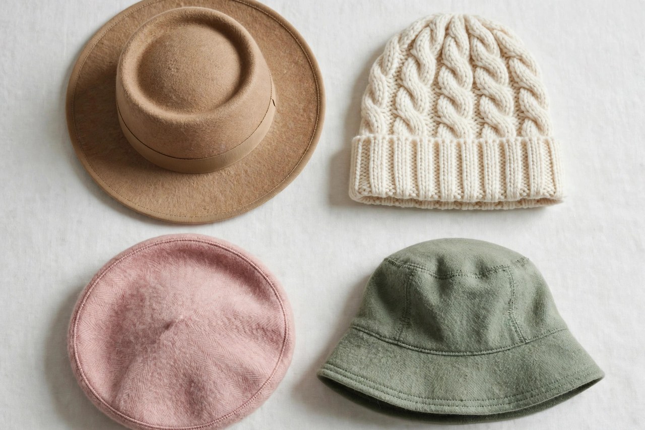Women's wool hats laid flat as a product photograph showing fabric and construction details