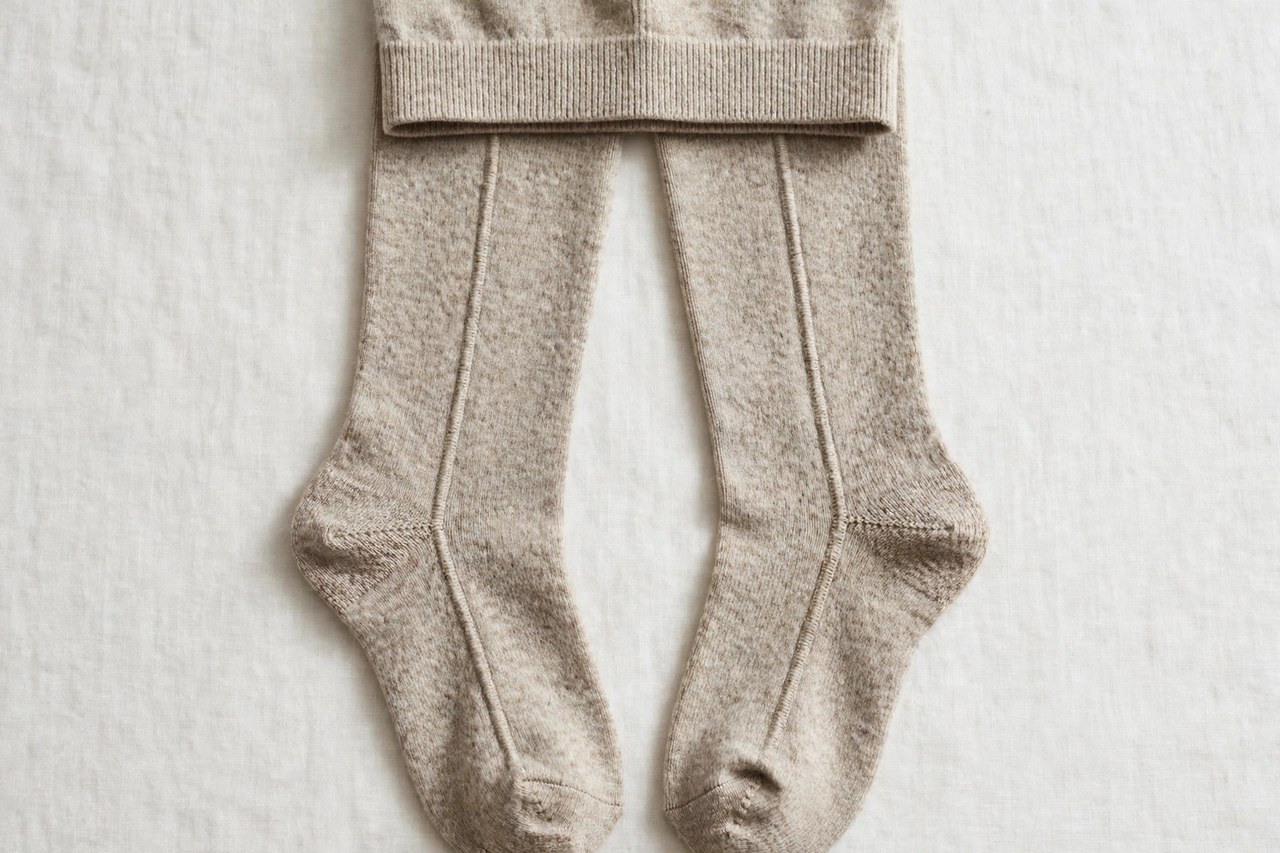 Women's wool tights laid flat as a product photograph showing fabric and construction details