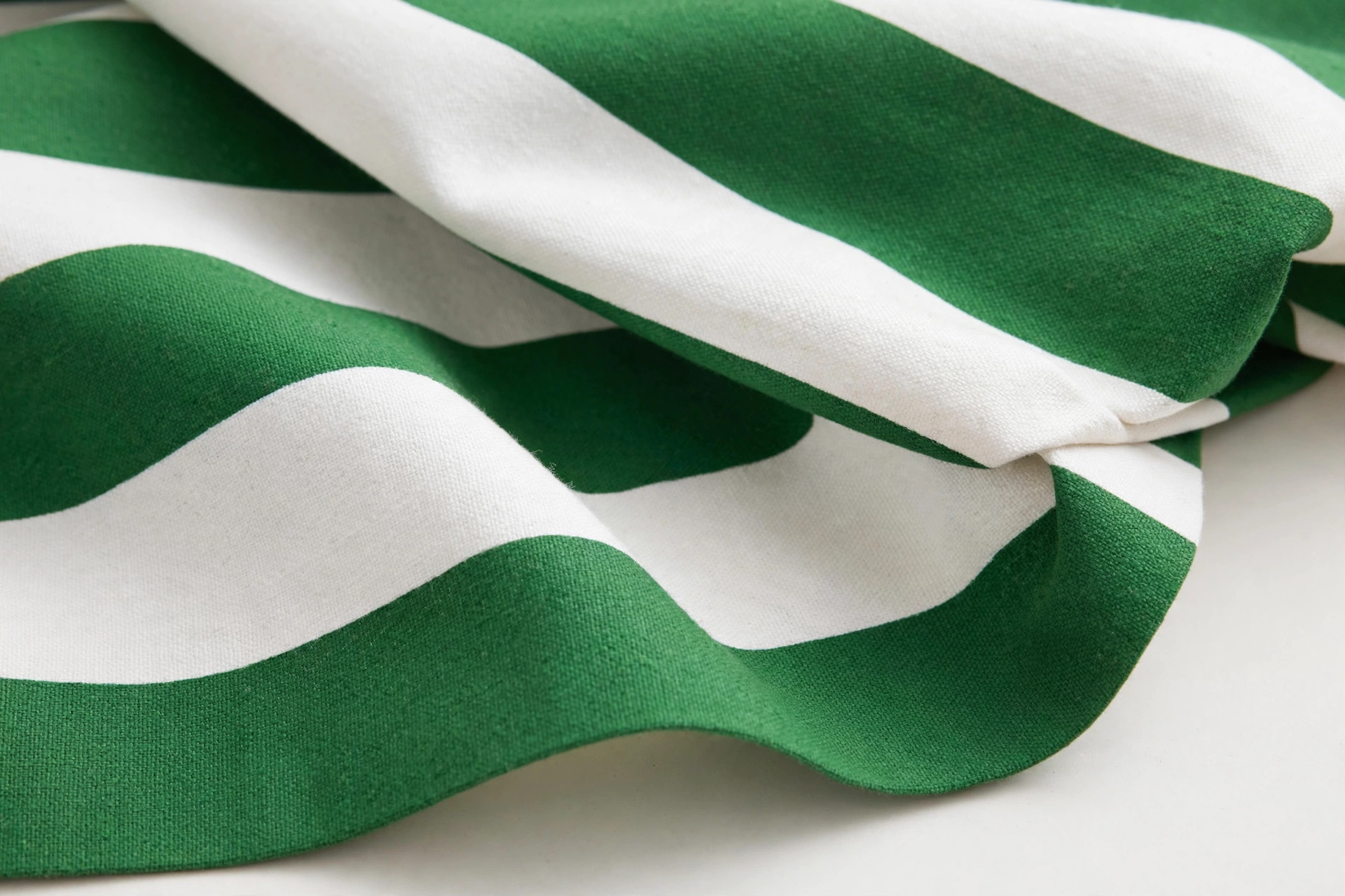 Wide green and white awning stripe fabric with bold bands