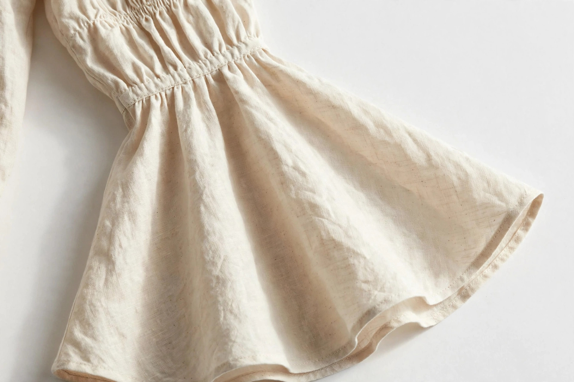 Close-up of a bell sleeve flaring wide at the wrist on a blouse