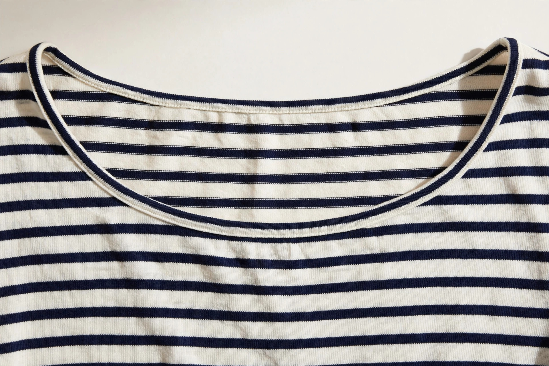 Close-up of a wide shallow boat neckline on a striped Breton top