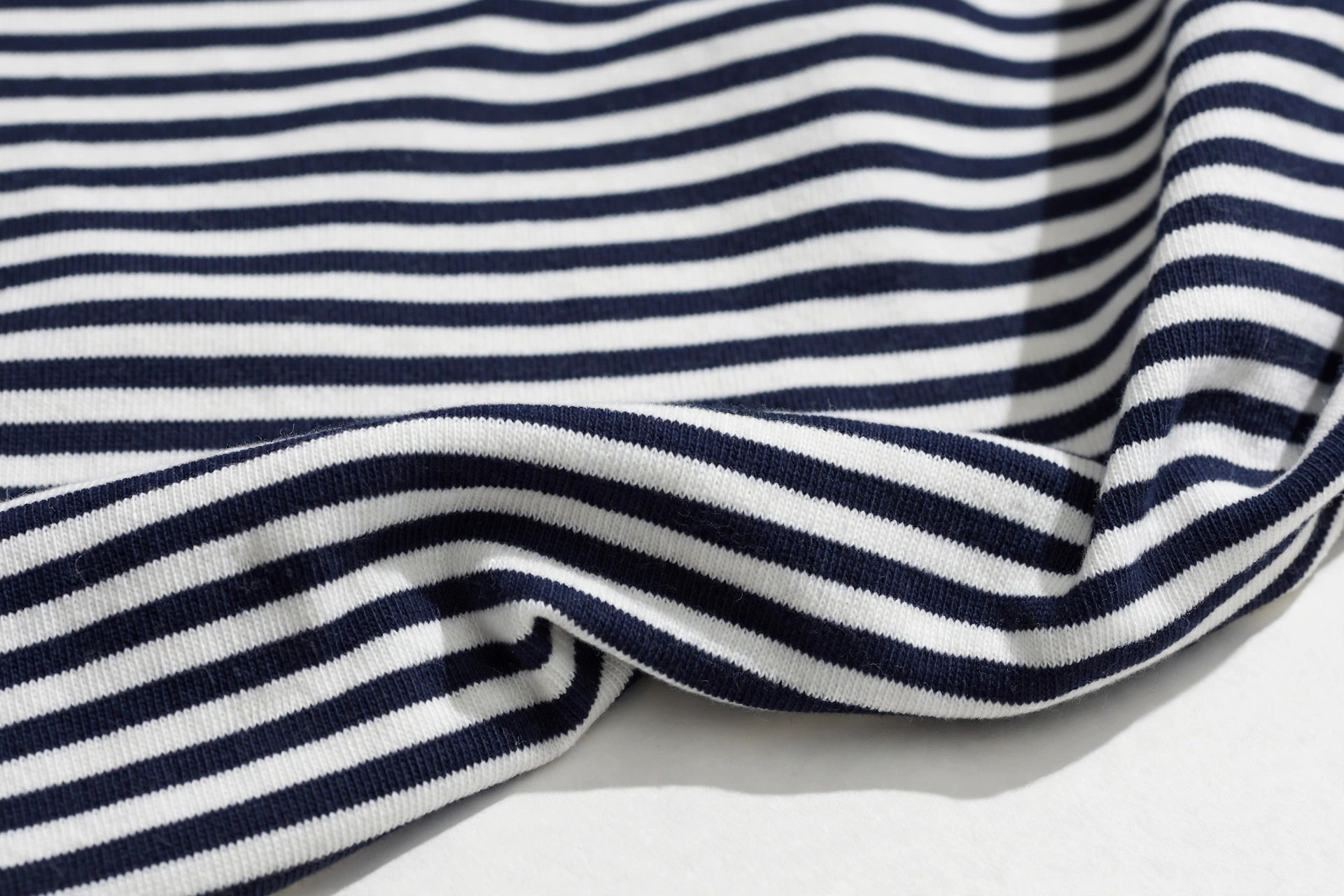 Classic navy and white Breton stripe knit top fabric with even horizontal stripes