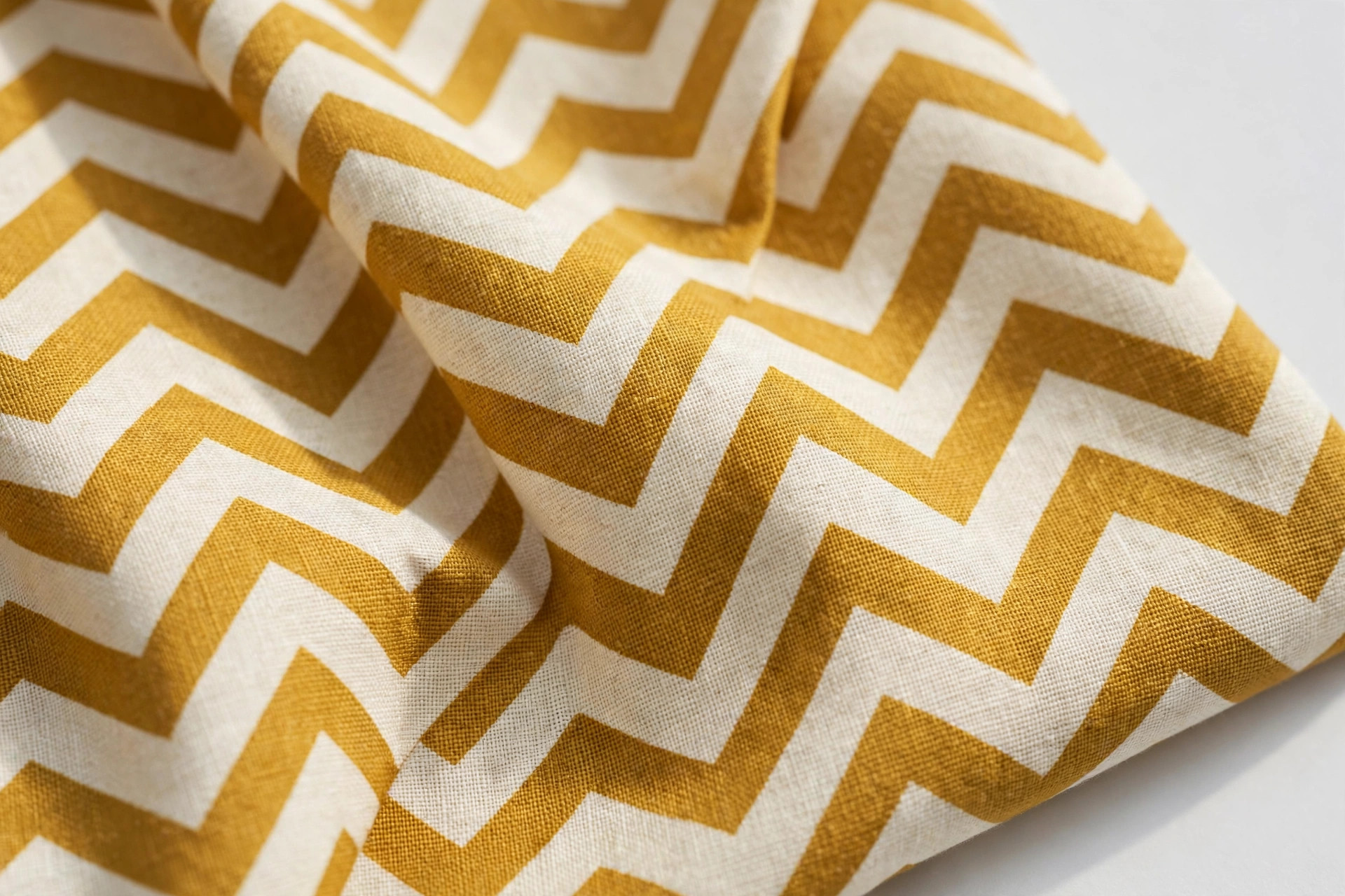 Chevron pattern fabric with bold zigzag V stripes in mustard and cream
