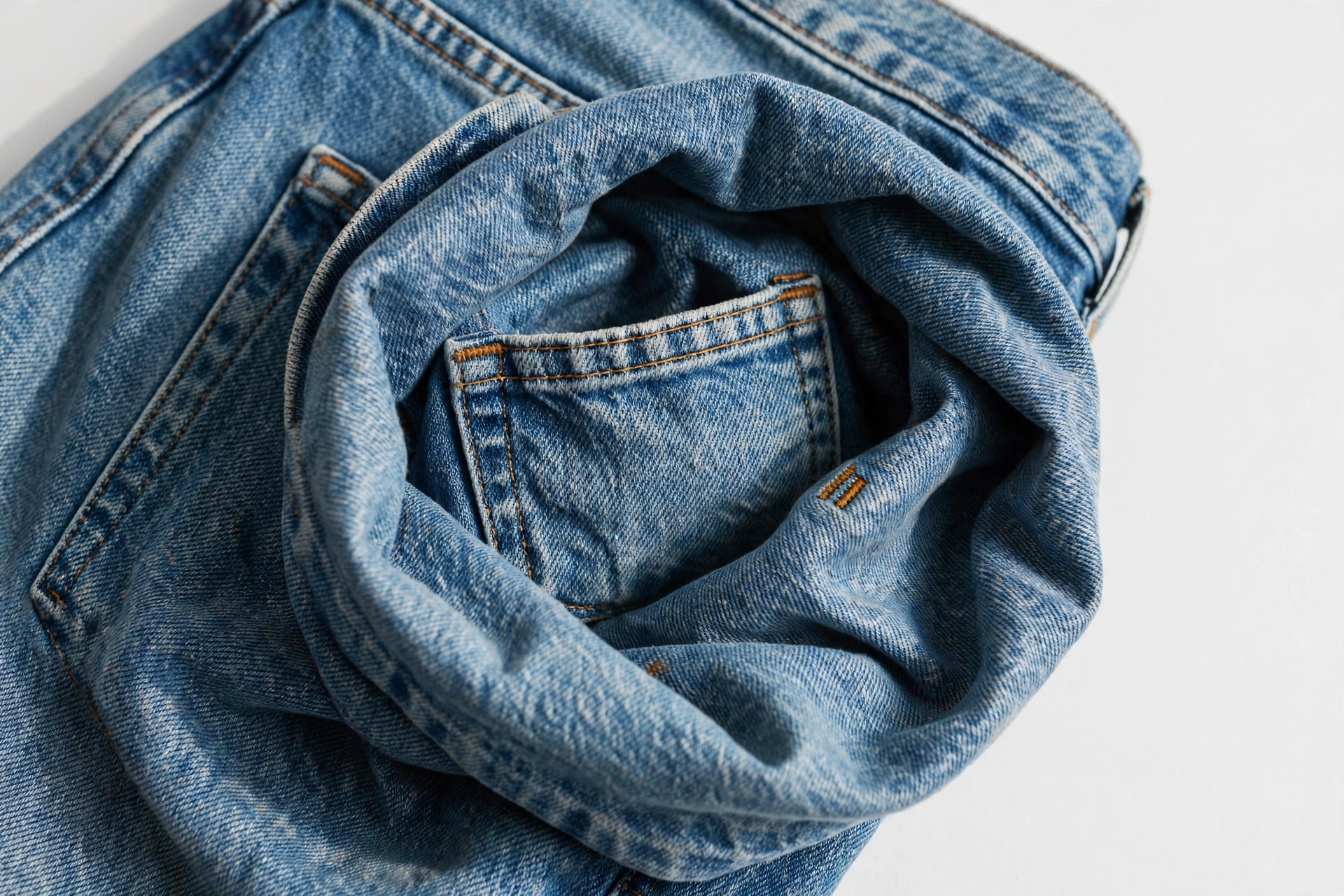 Close-up of the small coin pocket inside the front pocket of blue jeans