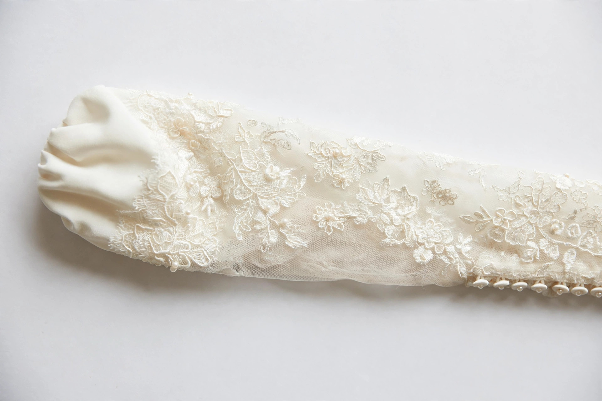 Close-up of a Juliet sleeve with small puff at the shoulder on a bridal gown