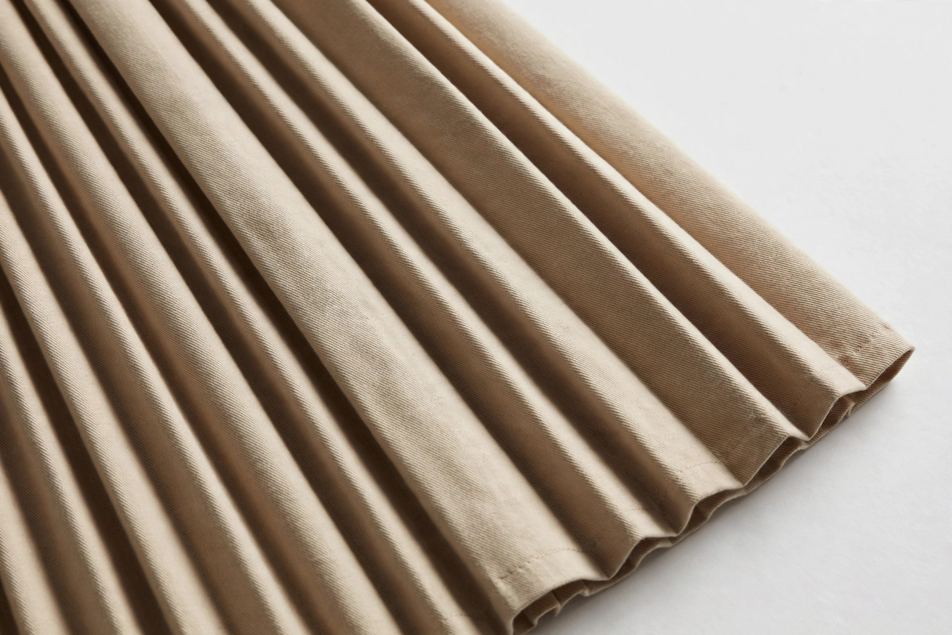 Close-up of sharp knife pleats all facing one direction on a skirt