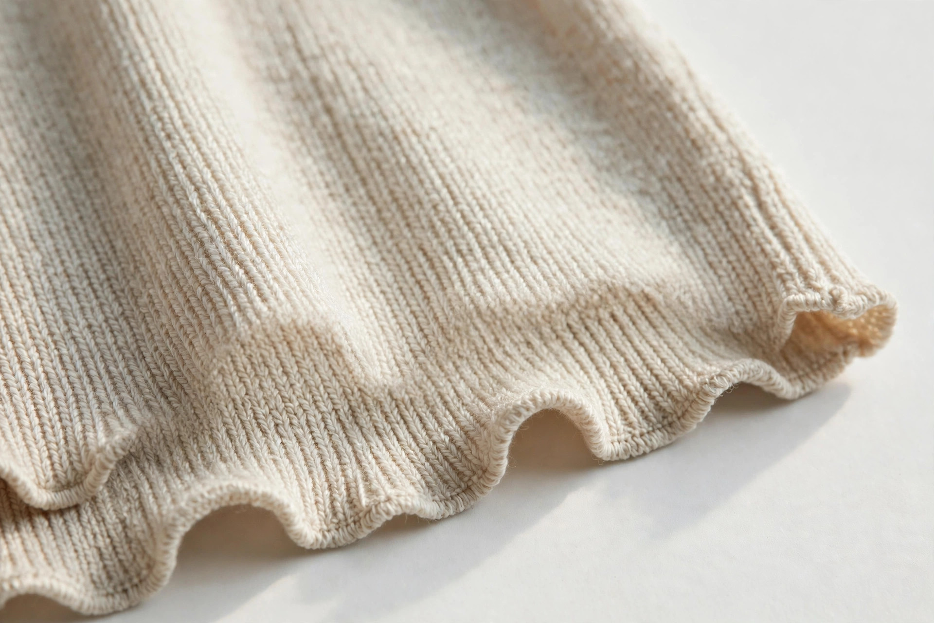 Close-up of a wavy lettuce hem on the edge of a knit top