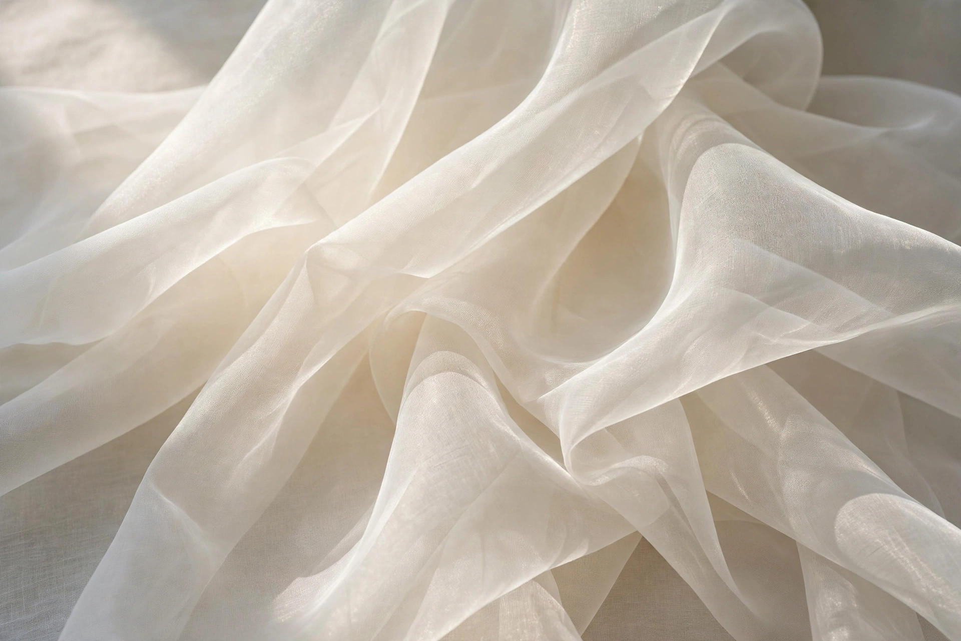 Sheer ivory organza fabric with a crisp translucent drape