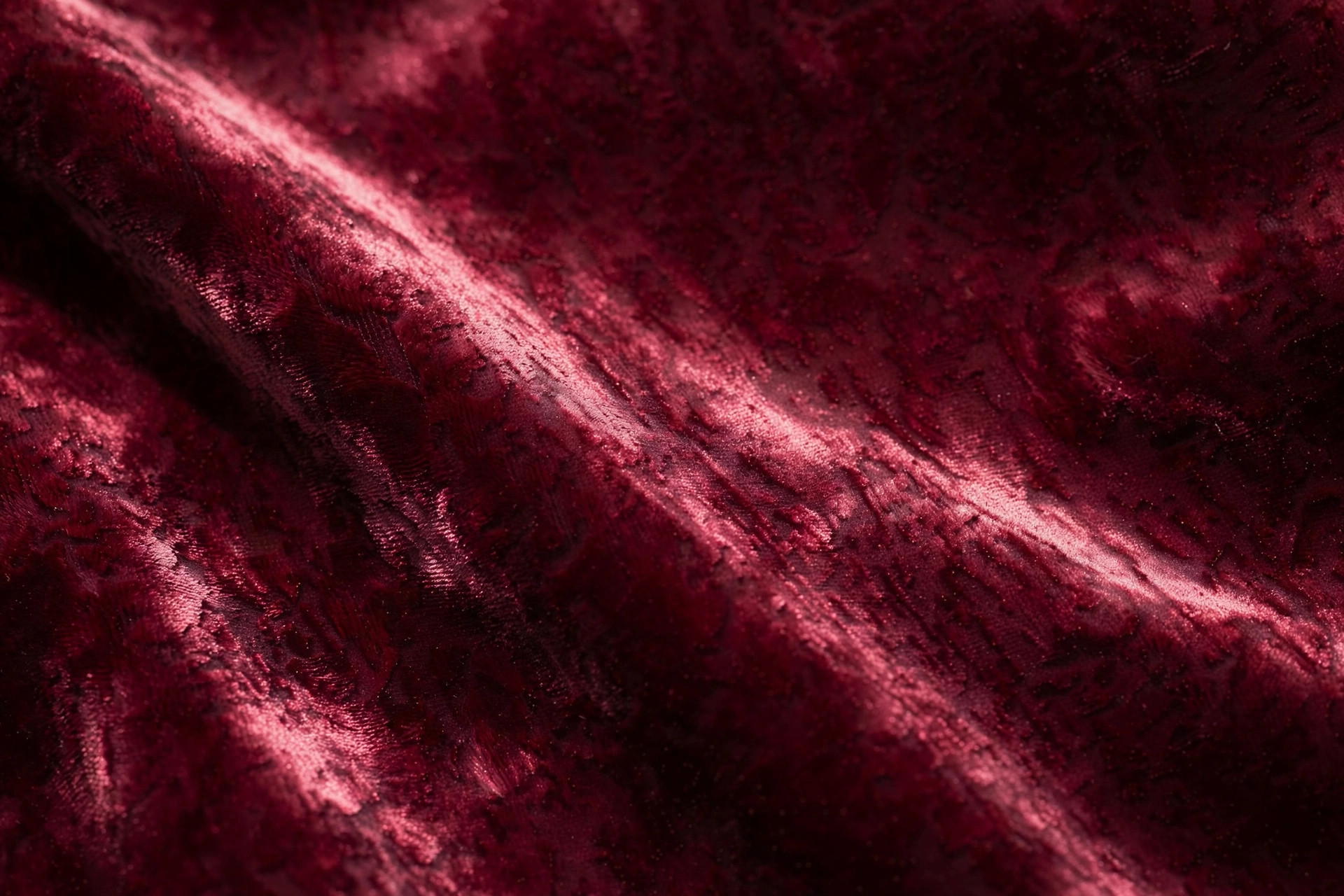 Lustrous panne velvet fabric with pressed pile in deep burgundy, catching the light