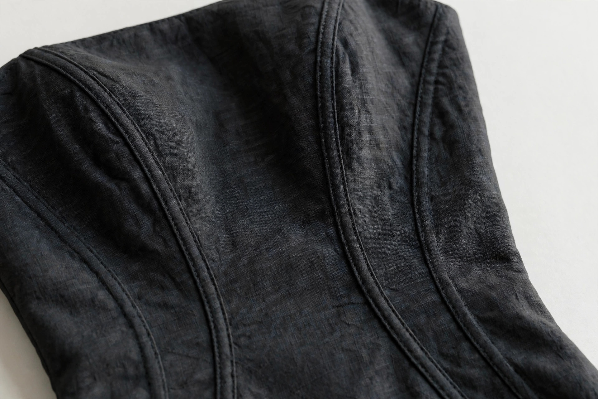Close-up of curved princess seams shaping a fitted dress bodice