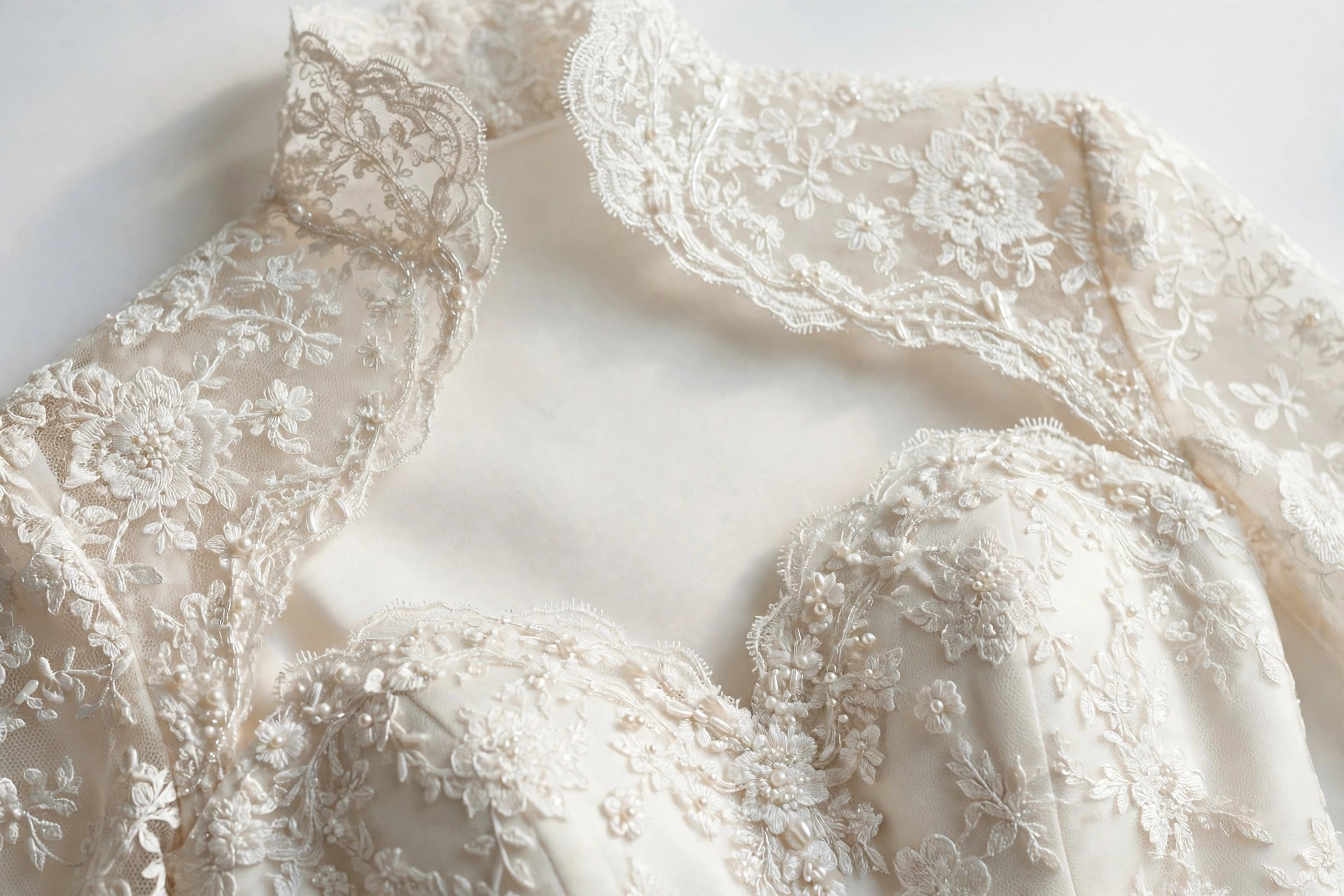 Close-up of a Queen Anne neckline high at the sides sweeping to a sweetheart front on a bridal gown