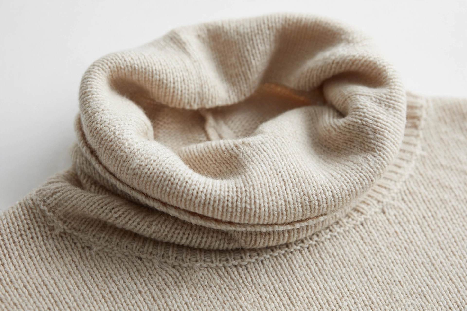 Close-up of a roll-neck turtleneck collar rolled over on a knitted sweater