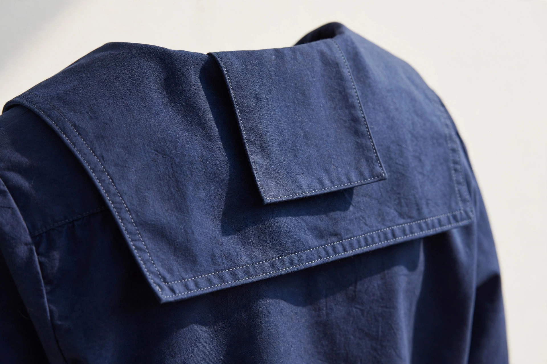 Close-up of a sailor collar with square back flap on a navy blouse