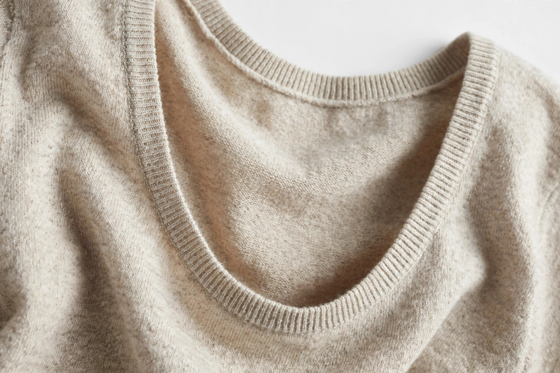 Close-up of a deep rounded scoop neckline on a casual knit top
