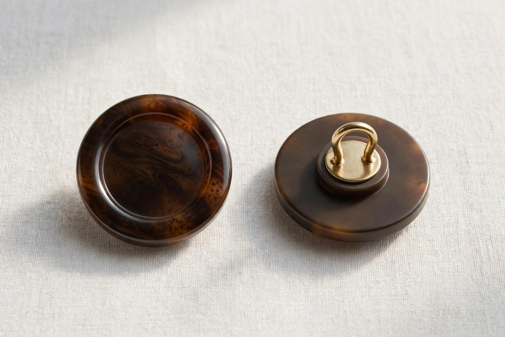 Close-up of coat buttons showing the metal shank loop on the back