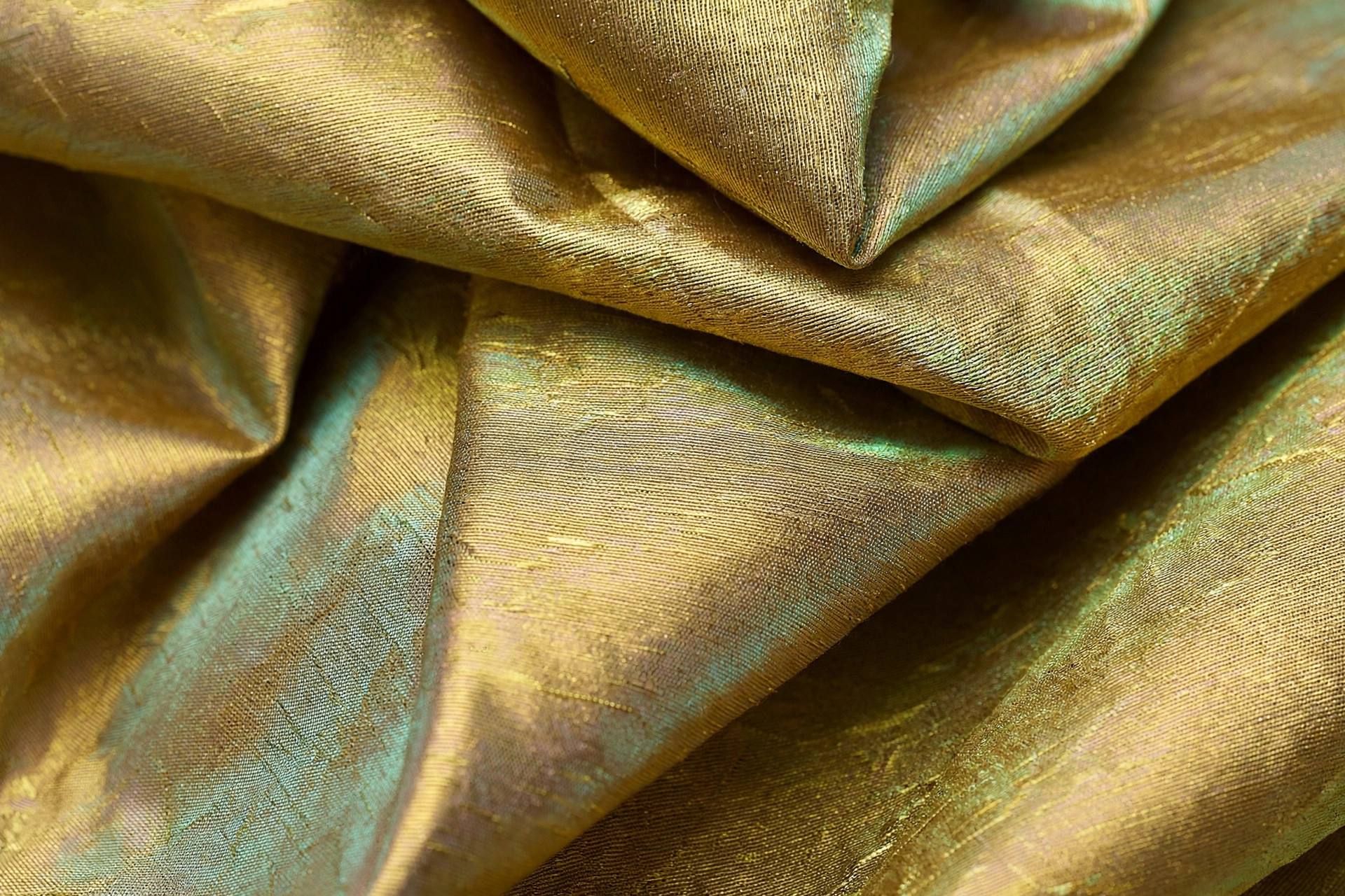 Iridescent gold shot taffeta with crisp structured folds