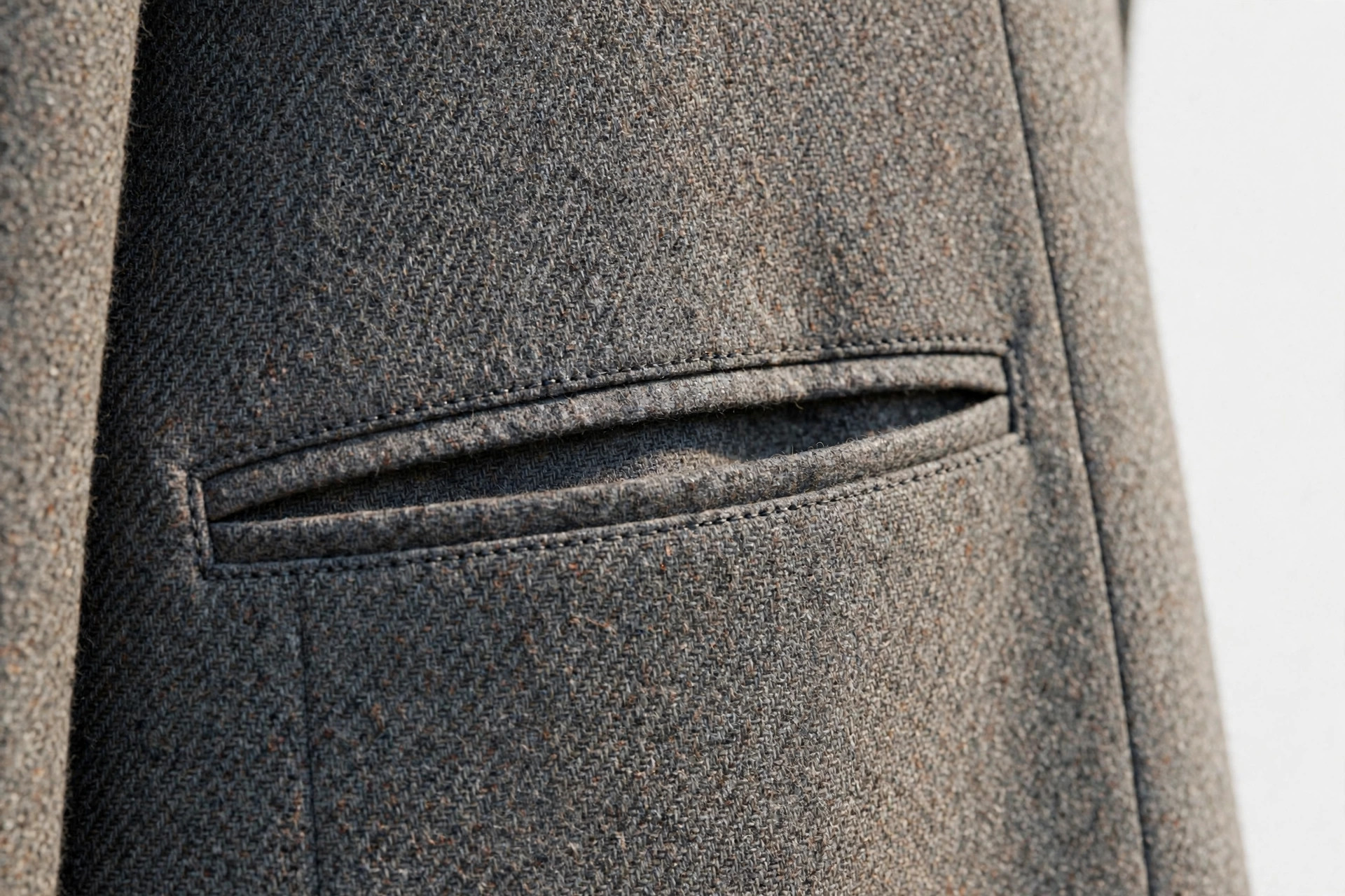 Close-up of a welt pocket on a tailored wool blazer