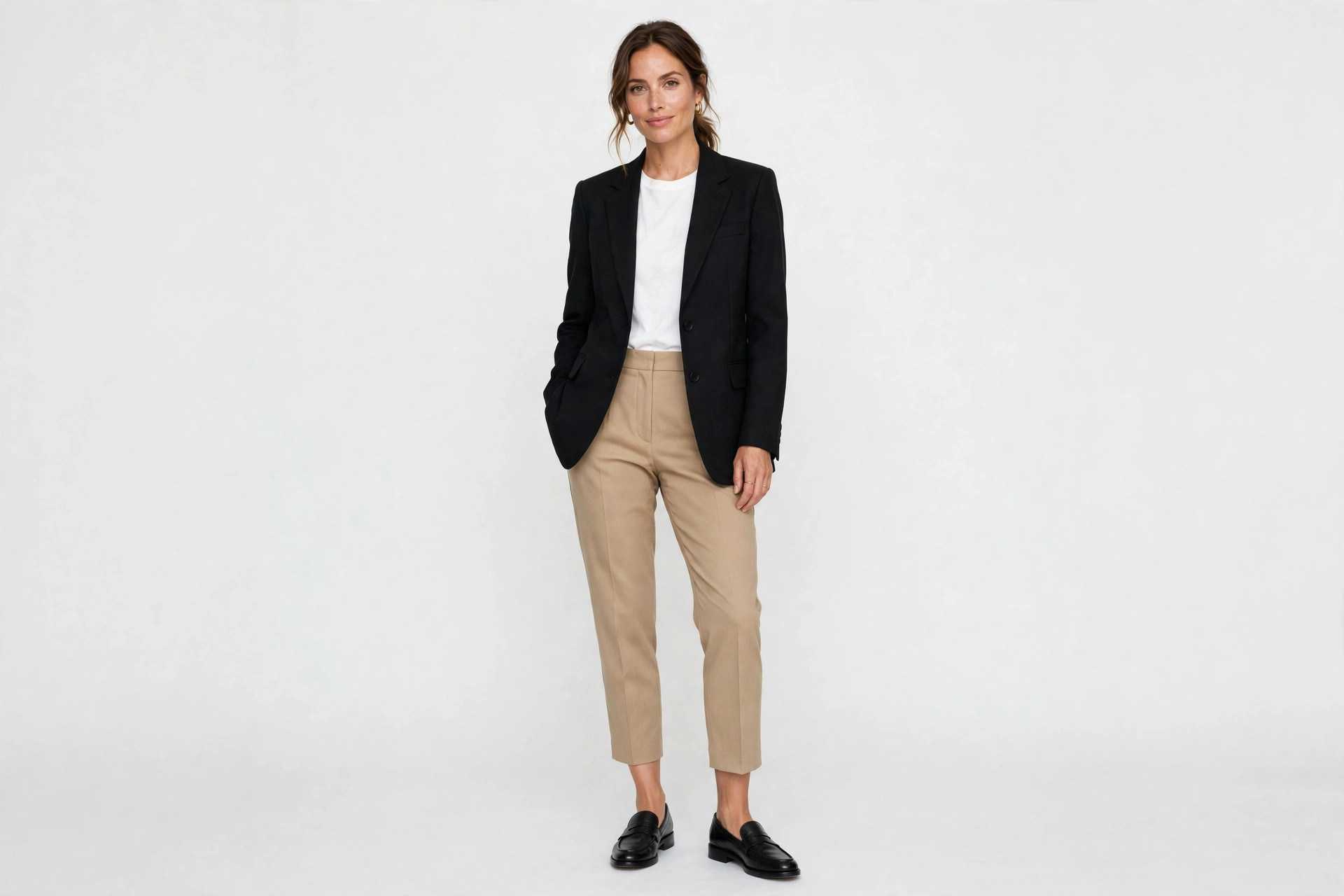 Woman wearing black leather loafers with cropped tailored trousers and a blazer