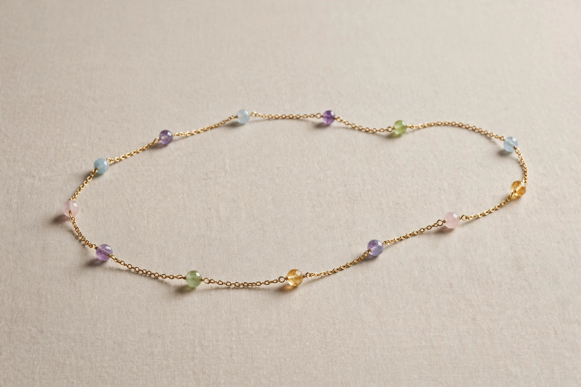 Delicate station necklace with gemstone beads spaced evenly along a fine gold chain